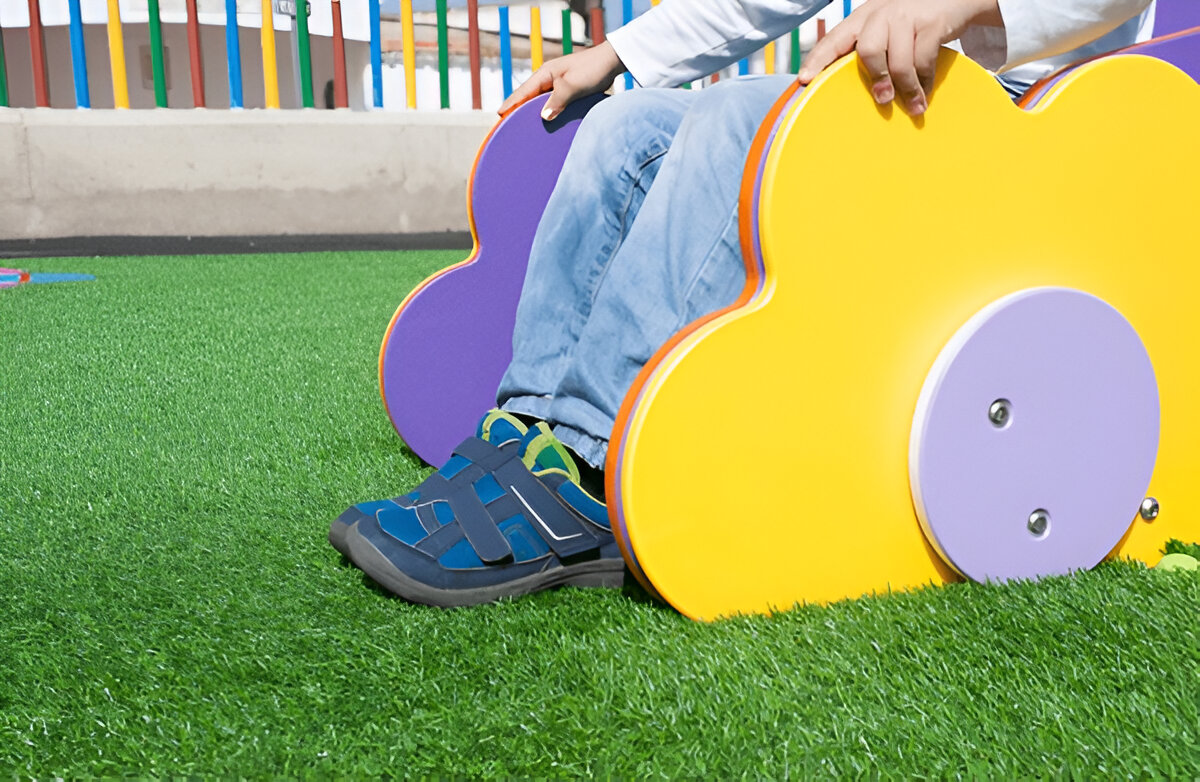 School playground with artificial turf installation and ADA compliant access pathways