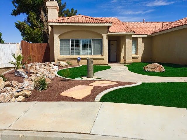Custom backyard putting green installation with sand trap fringe in Henderson