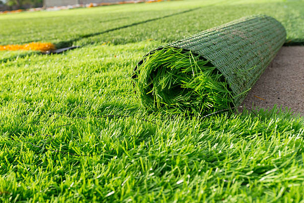 Modern residential home featuring clean, vibrant artificial grass in the front yard